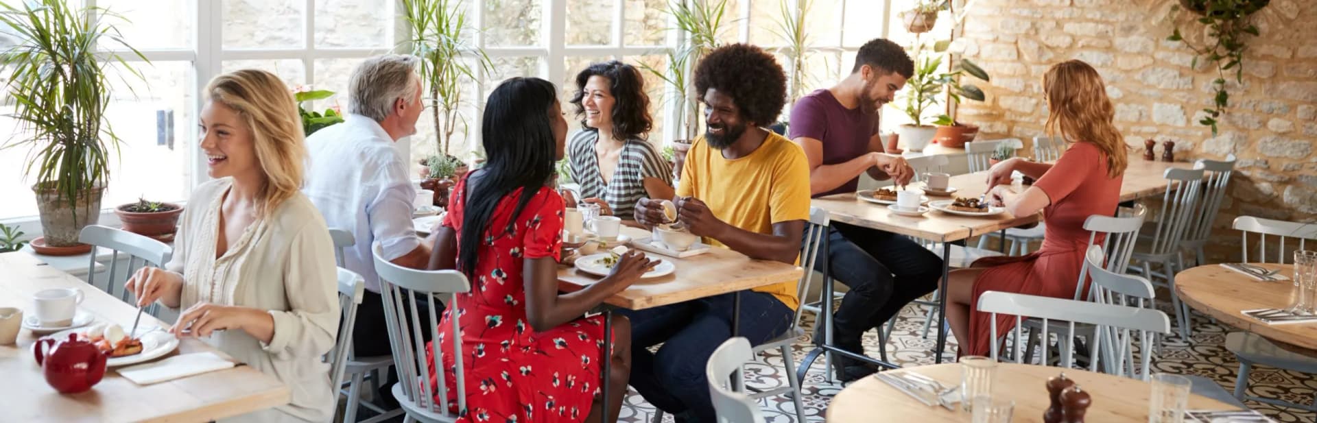 Server greeting guests at a restaurant table